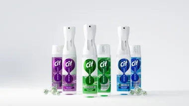 The image shows three Cif cleaning products in plastic spray bottles with refill packs shown alongside. There are three different product variants with purple, green and blue labels.