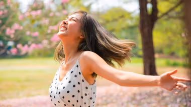 A girl running through a blossom tree